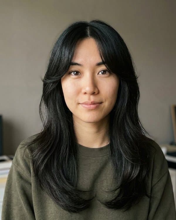 The same woman before and after curtain bangs: after